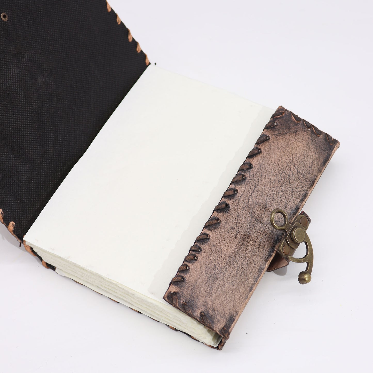 Carnet marron avec bords usés et motif mauvais œil